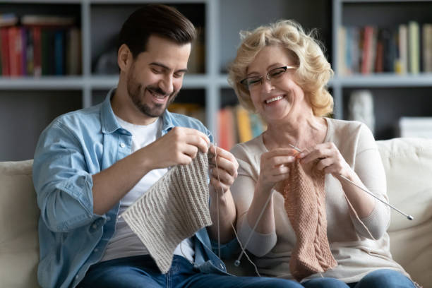 istock Cheerful loving two generations family creating warm clothes. 1320169762