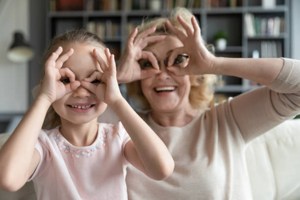 istock Happy small 7s kid girl making funny grimaces with granny. 1320170107