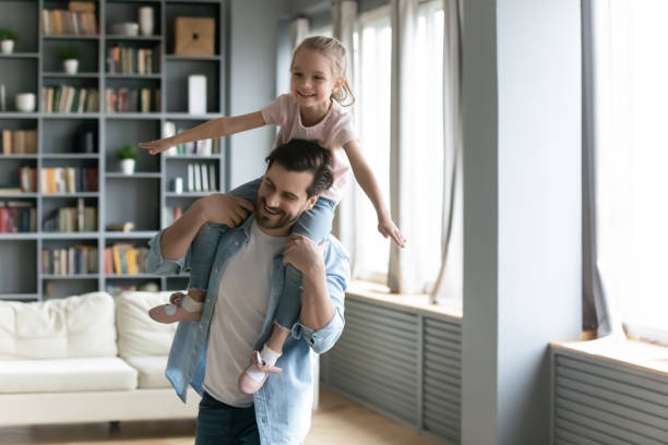 istock Happy young father carrying on shoulders laughing small daughter. 1320170274