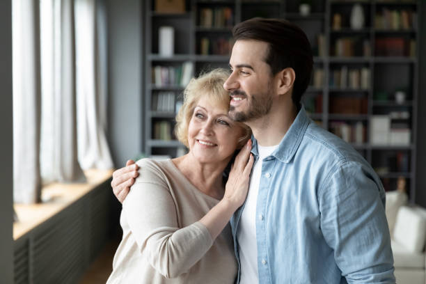 istock Happy dreamy affectionate bonding two generations family looking in distance. 1320170297