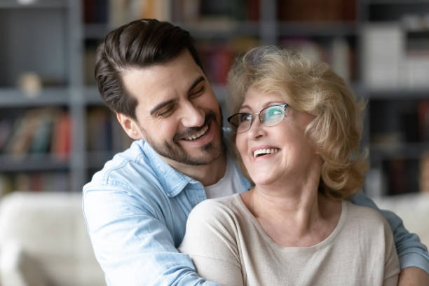 istock Happy young man embracing older mother at home. 1320170302