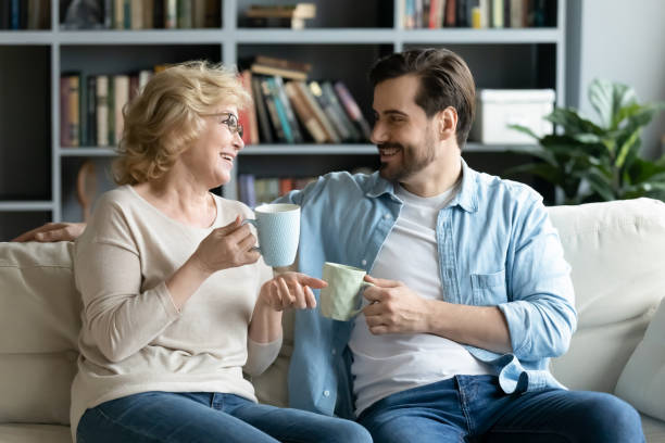 istock Smiling pleasant middle aged senior mother chatting with grown up son. 1320170306