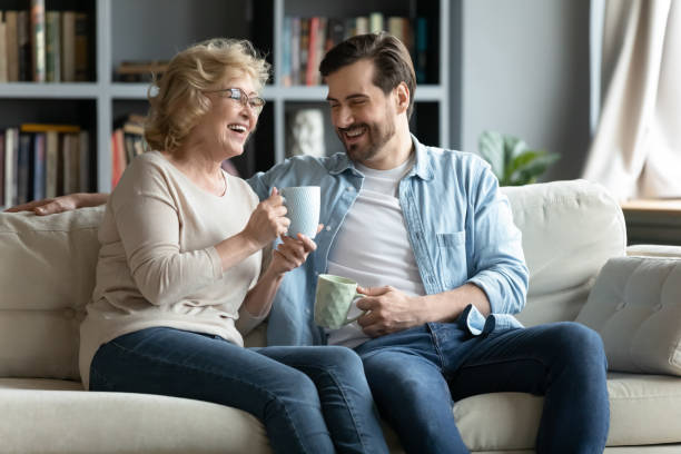 istock Happy older mature woman communicating with grown son. 1320170309