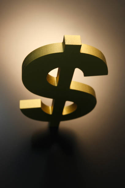 istock Gold Dollar Symbol On Warm Toned Background 1320170758