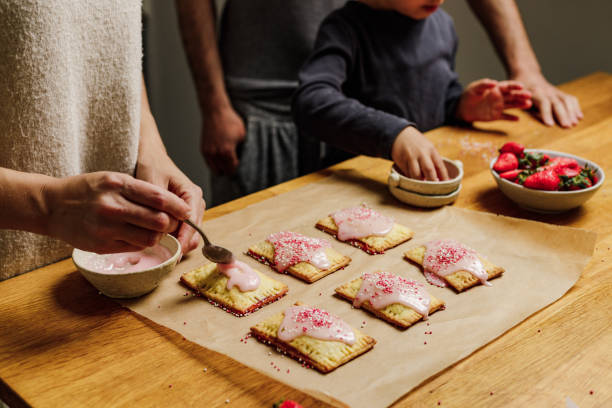 mother and son making pop tarts at home - family germany baking berlin germany imagens e fotografias de stock