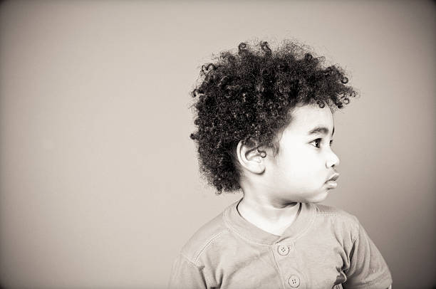 a black and white photo of a cute little boys profile