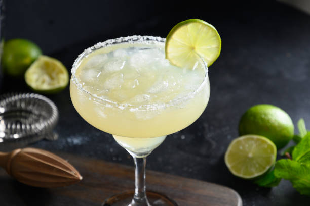 istock Margarita cocktail garnish lime and ice cube on black background. 1320174637