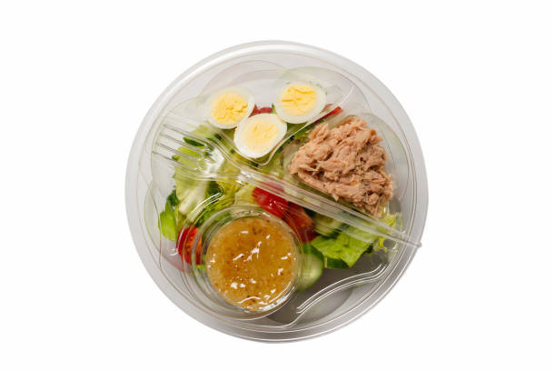 istock Fresh tuna salad with lettuce, cucombers, cherries and eggs in plastic container. 1320177546