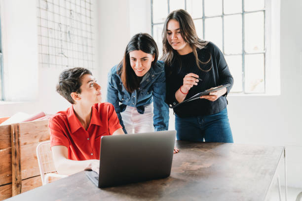 istock Three young adult women are working - studying together 1320177835