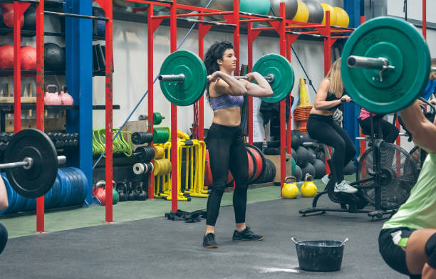 istock Woman practicing weightlifting in the gym 1320177925