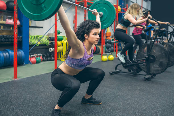 istock Woman practicing weightlifting in the gym 1320177928