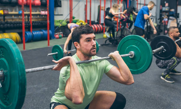istock Man practicing weightlifting in the gym 1320177931