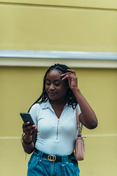 istock Cheerful african american woman using smartphone outside 1320182116