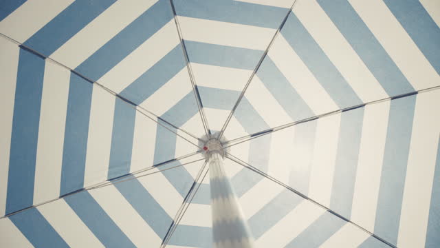 Umbrella parasol spinning under a strong summer sun