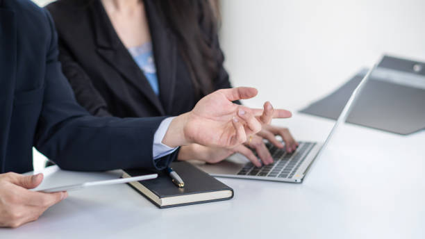 istock Businessman and businesswoman working in the office using a digital tablet and taking notes. 1320185255