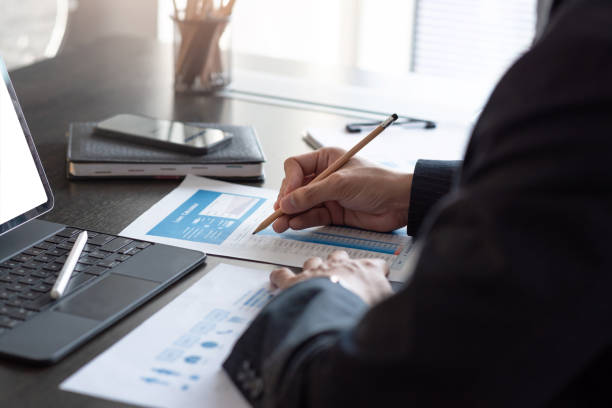 istock Businessman check information on document and a laptop on the table at the office. 1320185287