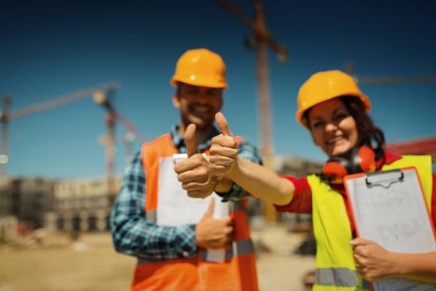 Thumbs up by coworkers on construction site