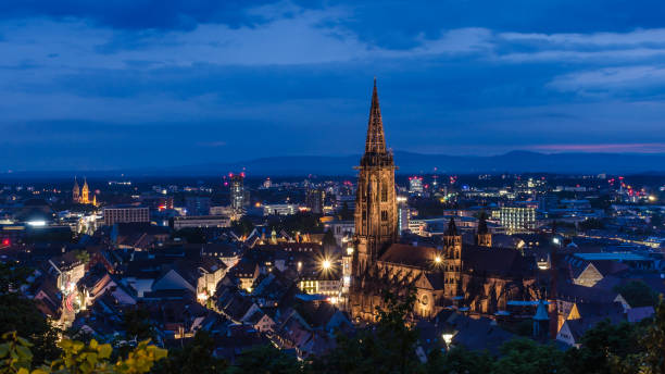 Blue Hour in Freiburg View from the Schlossberg to Freiburg with the cathedral at the Blue Hour in the evening. munster stock pictures, royalty-free photos & images