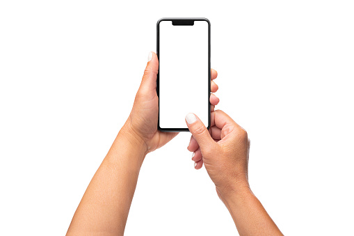 Close up view of a female holding with two hands a smartphone with blank screen straight up isolated on white background. Copy space on smartphone screen and in background