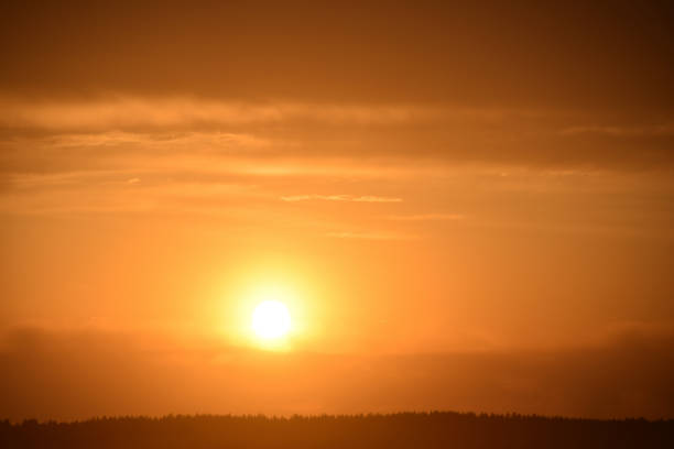 istock Sunset sun on the horizon with clouds in the evening 1320188856