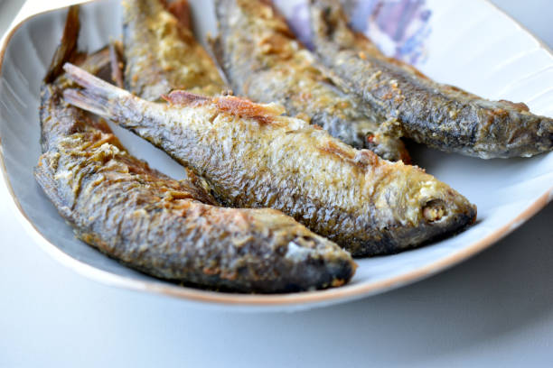 istock Freshly fried river fish in a plate in the kitchen 1320188890