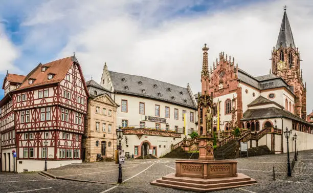 View of the historic Stiftsplatz in Aschaffenburg with the Collegiate Church of St. Peter and Alexander, the Stiftsbrunnen, the Löwenapotheke and the Stiftsmuseum.