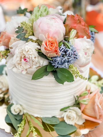 Stunning white wedding cake with gorgeous fresh spring florals on top