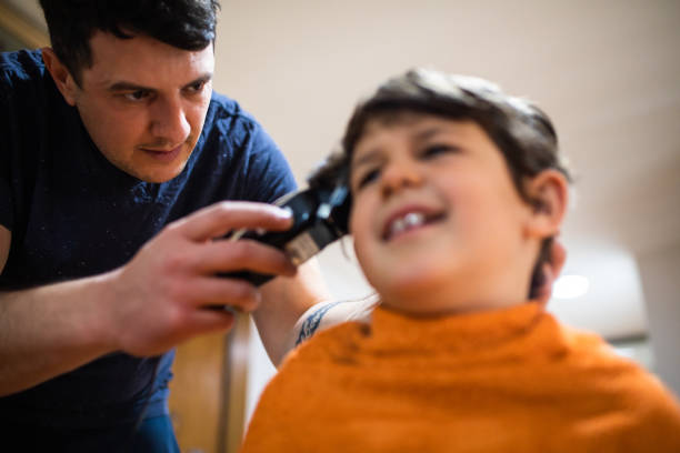istock A young father giving his son a home haircut 1320189498