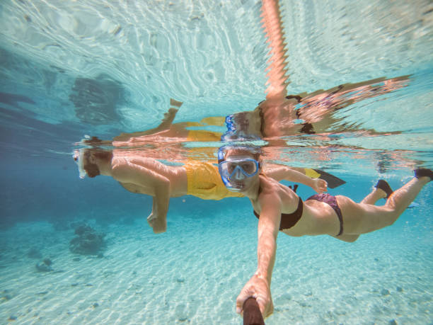Young couple take selfie underwater with snorkelling mask