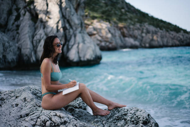 istock Young relaxes on rocky coastline near Mediterranean beach 1320193066