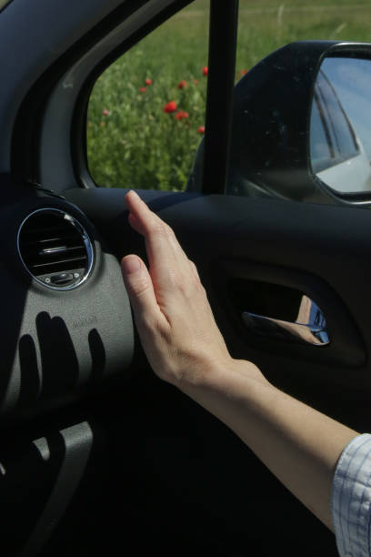 hand checking the air conditioner in the car - car air conditioner vehicle interior driving imagens e fotografias de stock