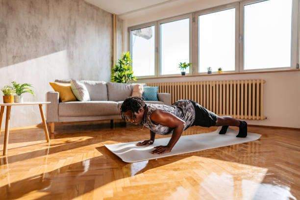 istock Man doing push ups in his living room 1320198768