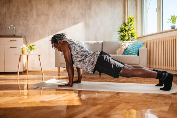 istock Man doing push ups in his living room 1320198810