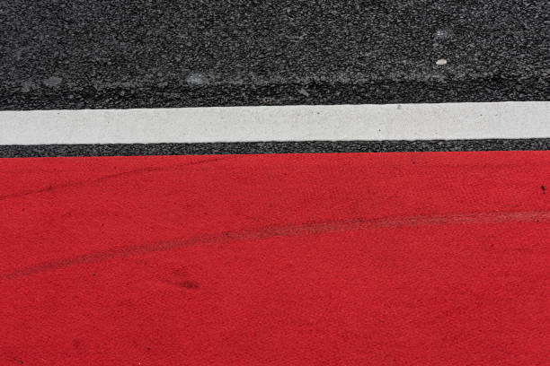istock Asphalt decorated with a white line and a red field.. 1320198833