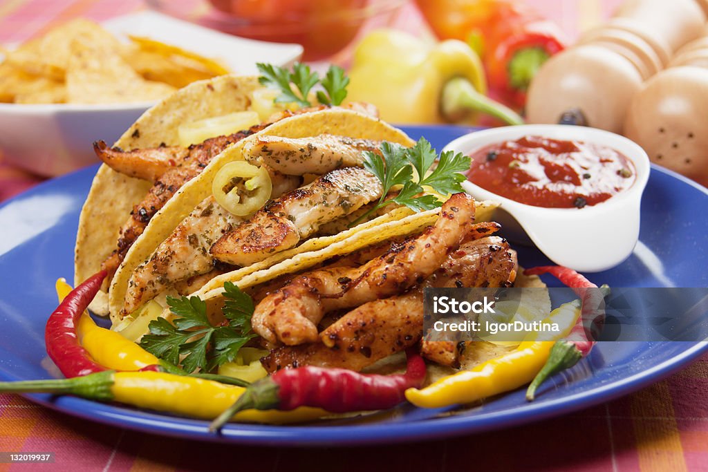 Grilled chicken meat in taco shells Grilled chicken meat, vegetable and hot chili peppers in taco shells Chicken Meat Stock Photo