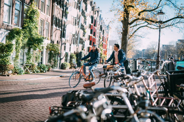 istock Gay couple on city break, commuters using bicycles 1320199615