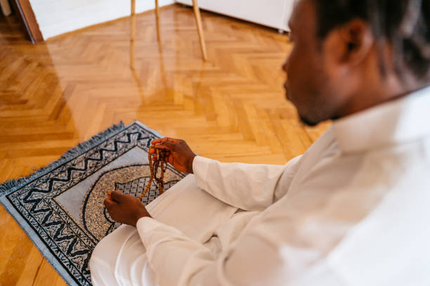 istock Muslim man is praying at home 1320199871