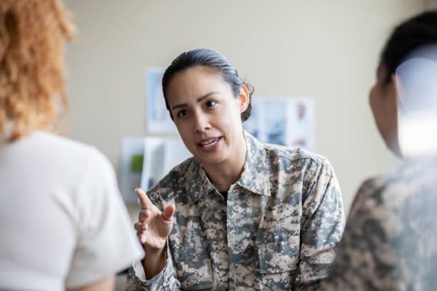 istock Adult military woman speaking during group therapy session 1320205497