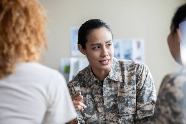 istock Adult military woman speaking during group therapy session 1320205500