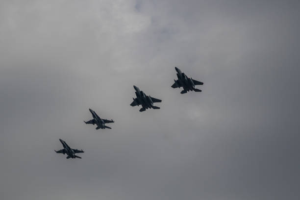 F18 and F15 Flying In Formation Montreal, Quebec, Canada - 05 26 2021: NORAD exercise in Montreal. The USAF and RCAF practice together in the Montreal city area. 2 F18 and 2 F15 flying in formation. fa 18 hornet stock pictures, royalty-free photos & images