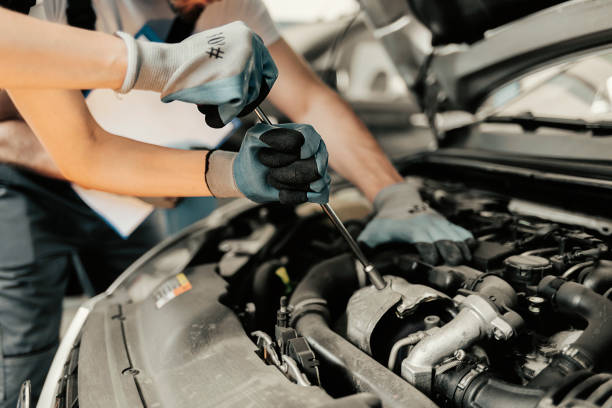 istock Working on Car Engine in Mechanics Garage 1320209153