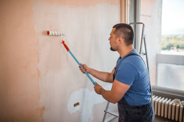 istock Diligent worker painting his room 1320209274