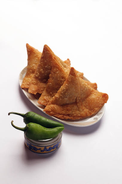 Isolated Potato Samosa Snacks on White Background. Indian Ramadan Food, Pakistani Iftar Meal.