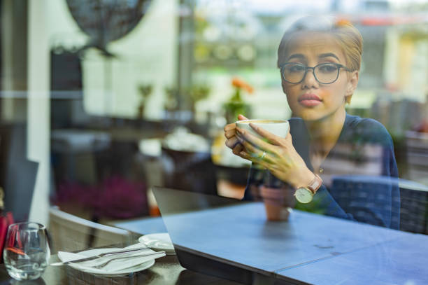 istock Yong woman drinking coffee in cafeteria 1320209674