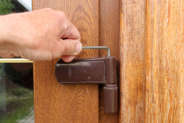 istock Adjusting the door hinge with a hex wrench. 1320209831