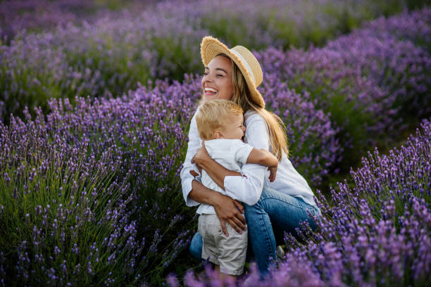Nothing warms the heart like a hug Mother and her son bonding together outdoors at the lavender field warms stock pictures, royalty-free photos & images