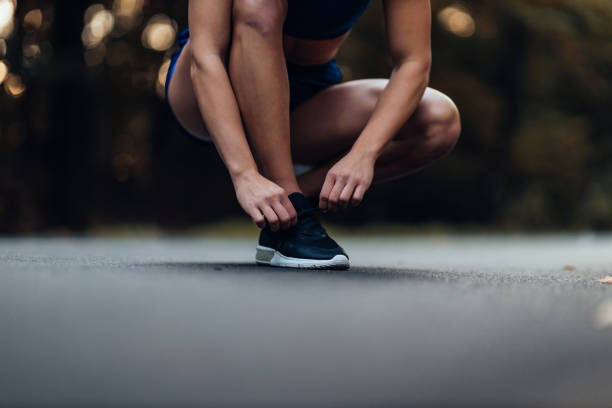 istock Woman tying shoelaces before workout 1320213134