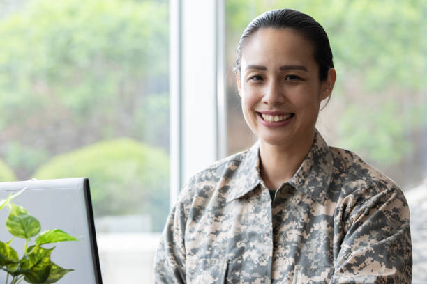 istock Mature mixed race military woman smiling while working at her desk 1320214061