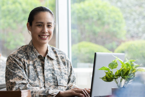 istock Mature mixed race military woman smiling while working at her desk 1320214069