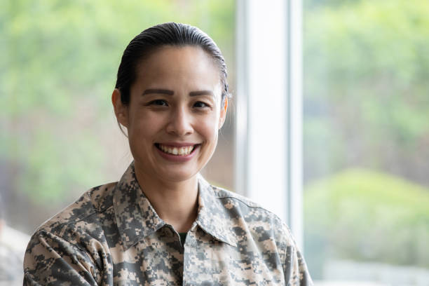 istock Mature mixed race military woman smiling while working at her desk 1320214073
